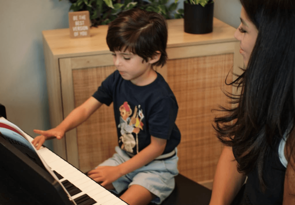 Student and teacher during a first piano lesson