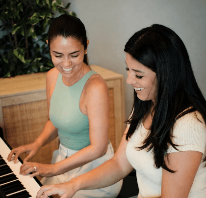 Frances teaching a student at the piano